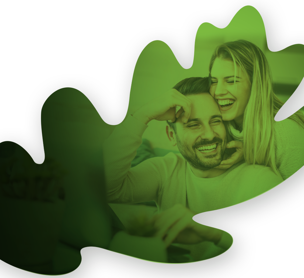 A green oak tree leaf with a smiling couple overlaying the leaf